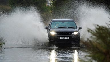 A car goes through floodwater in Whitley Bay, in North Tyneside, after heavy overnight rain. Picture date: Tuesday October 5, 2021.